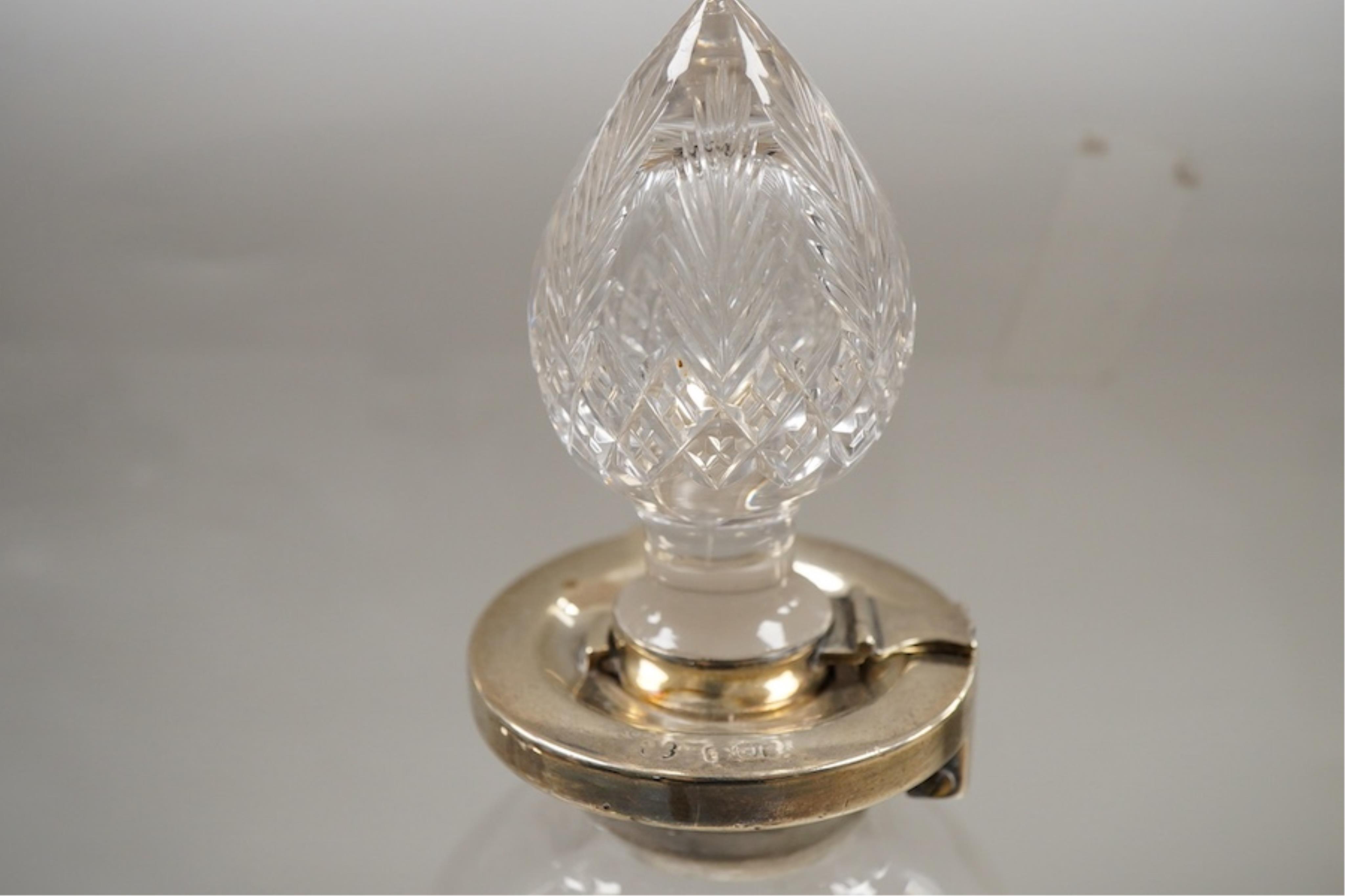 Three assorted silver mounted cut glass decanters, including two modern and one earlier with lock, marks rubbed, no key, the latter 34.1cm.